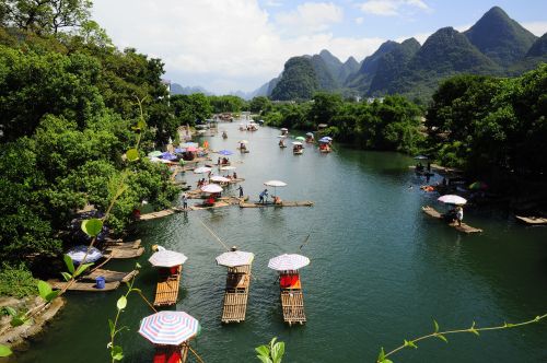 Mostly Chinese People floating through the beautiful landscape on rafts